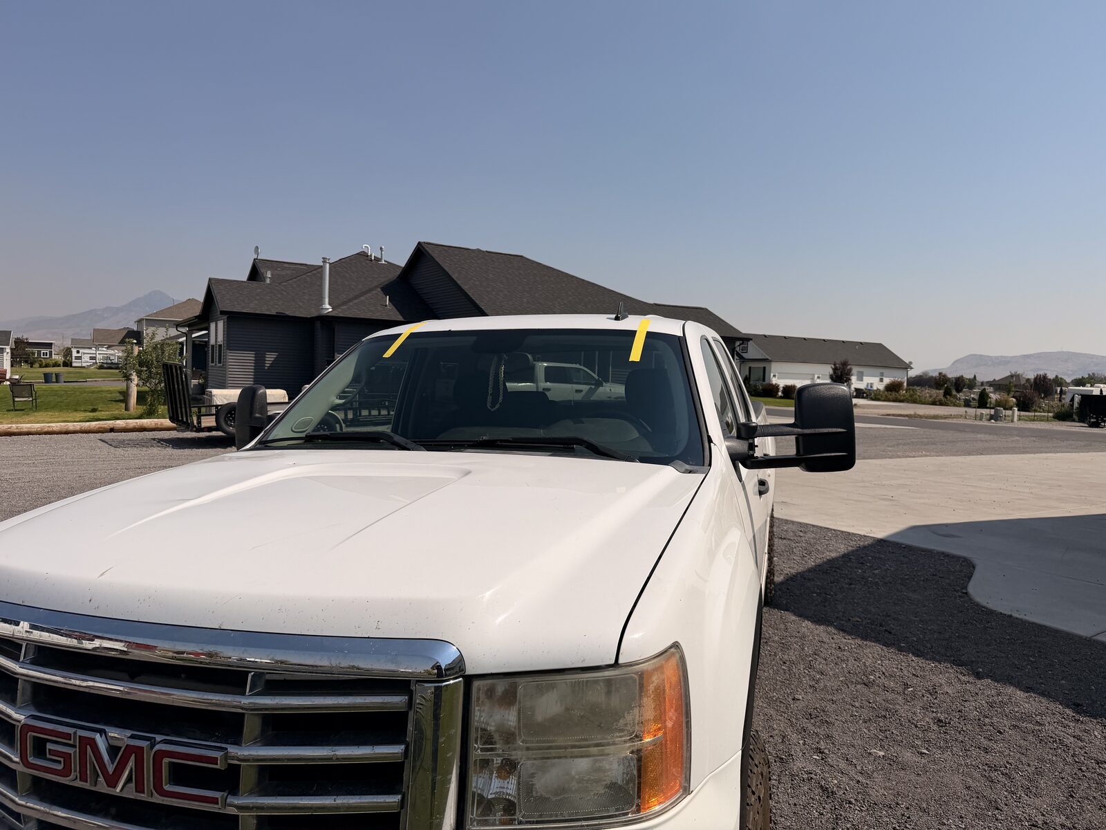 Curing tape in place after a same-day mobile windshield replacement.