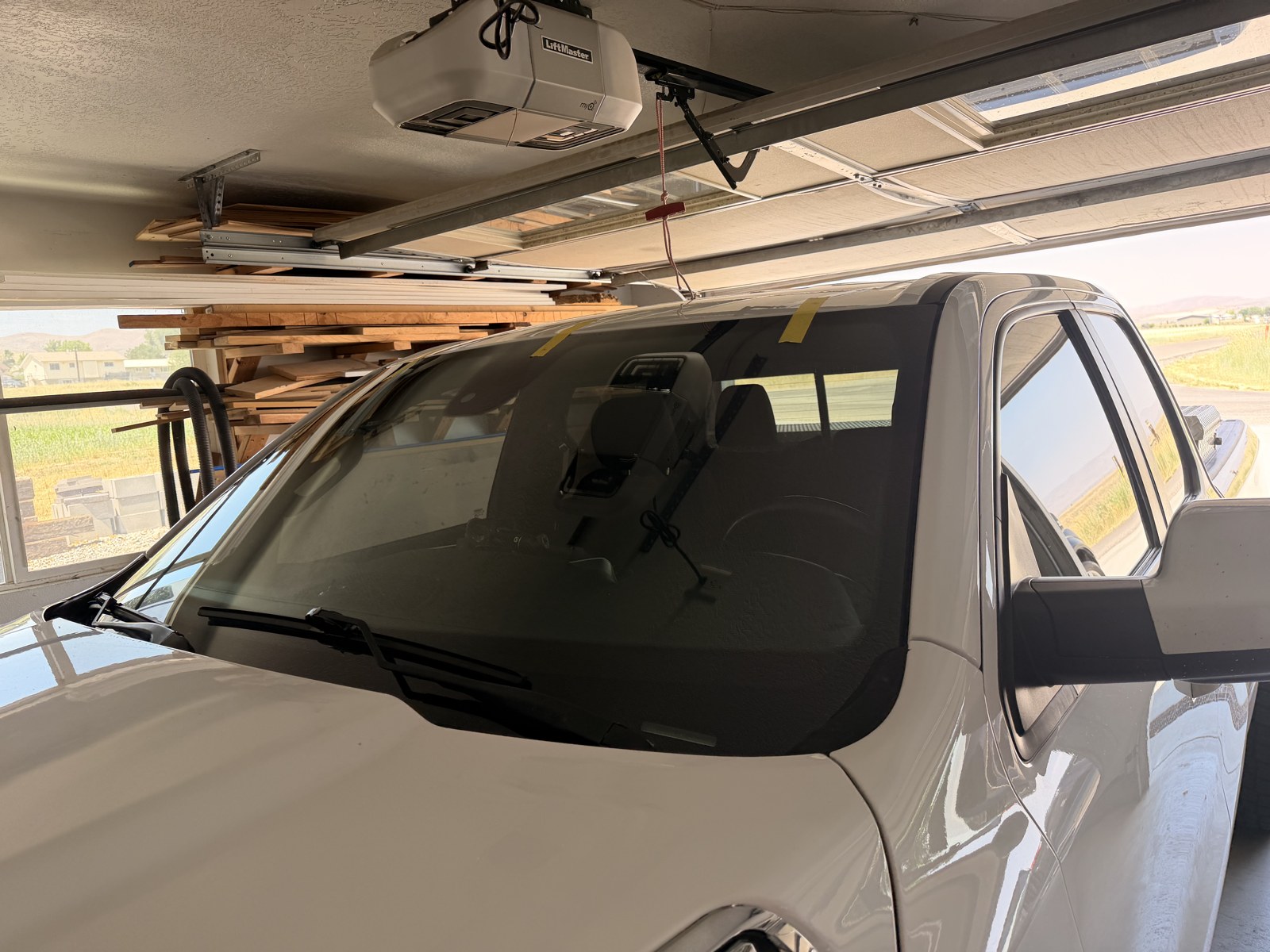 Pickup windshield replacement finished on-site in the customer's garage.