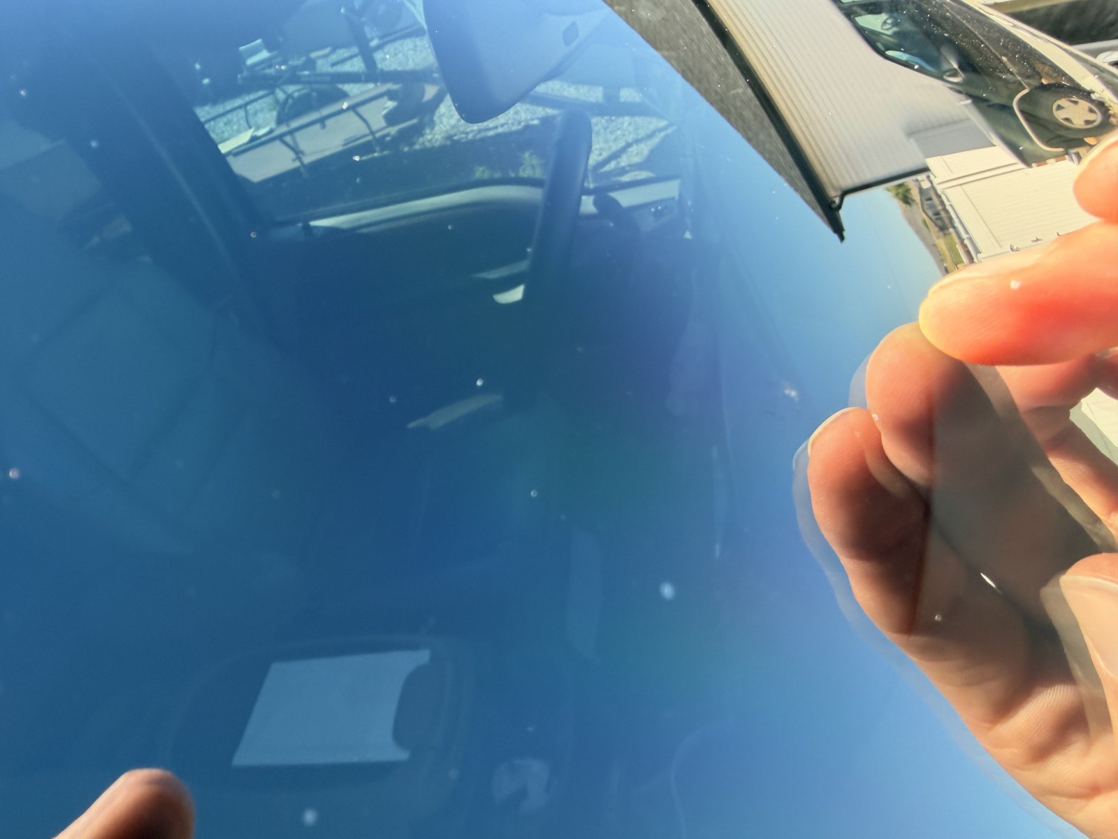 Close-up quality check on freshly installed glass before handing back the keys.