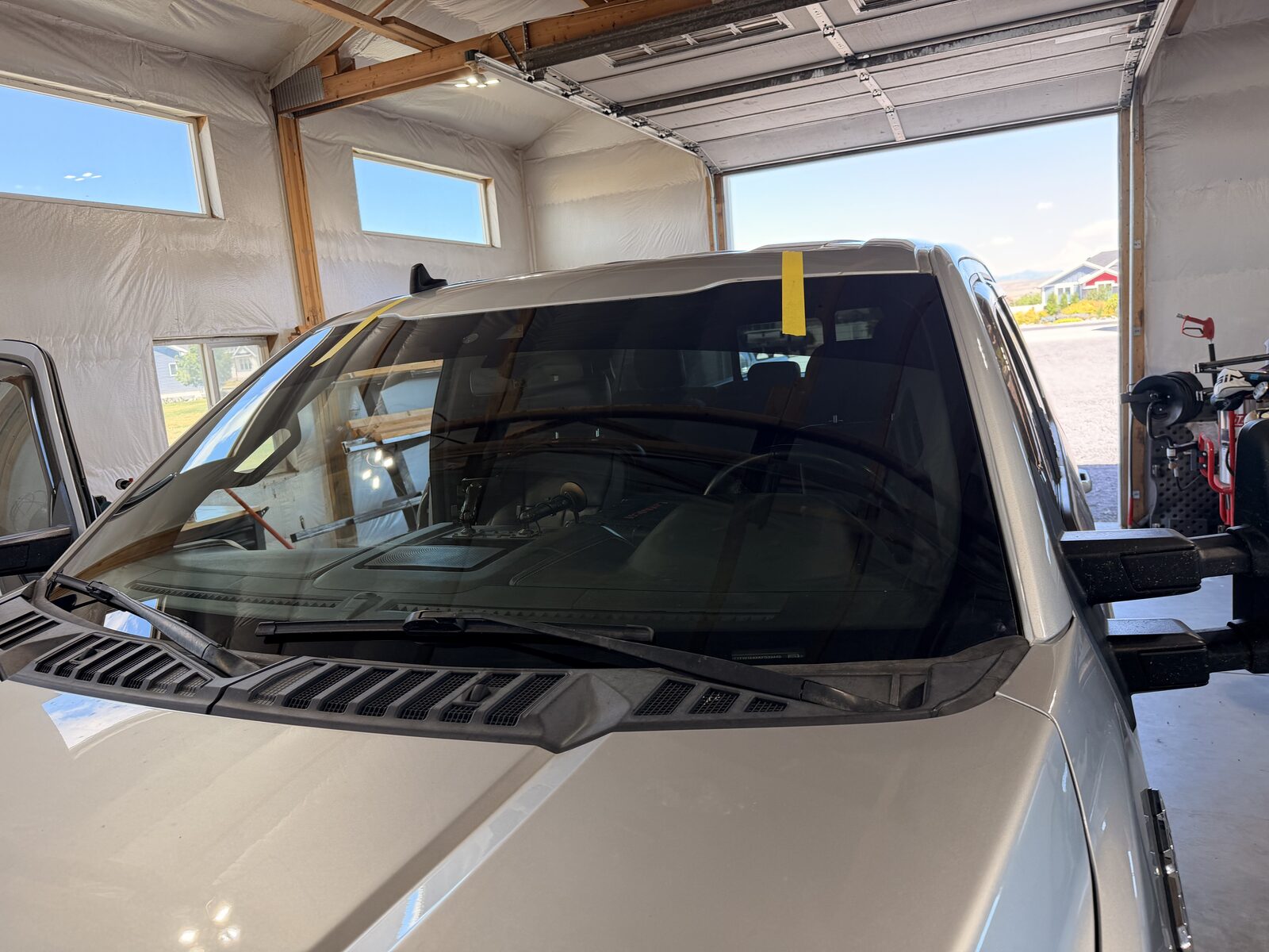Full windshield replacement on a late-model truck, finished in the shop bay.